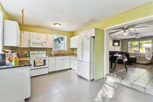 kitchen featuring light tile floors, ceiling fan, tasteful backsplash, white appliances, and white cabinets