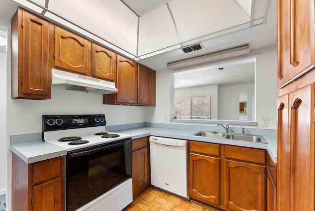 kitchen featuring light parquet flooring, sink, and white appliances