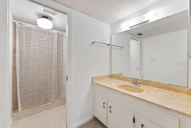 bathroom with vanity and a textured ceiling