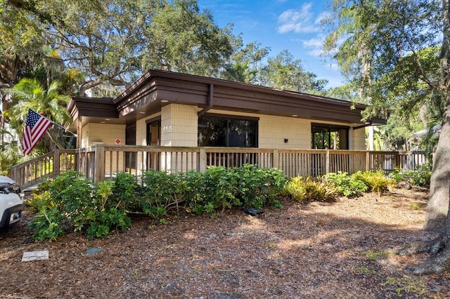 view of property exterior with a deck