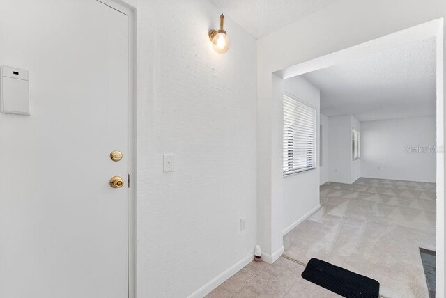 hallway with light colored carpet