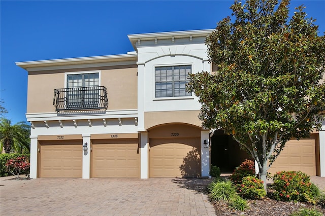 view of front of house with a balcony and a garage