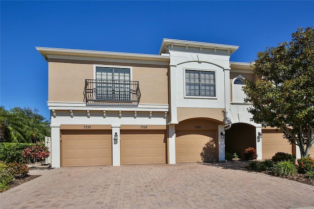 view of front of property with a balcony and a garage