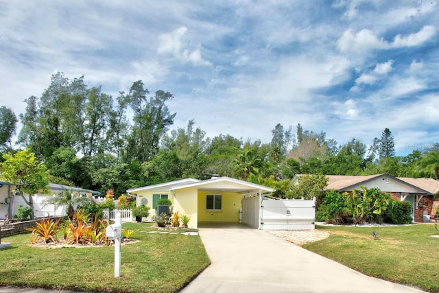 ranch-style home featuring a carport and a front yard