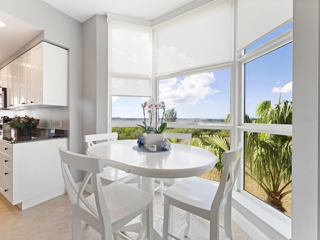 tiled dining area with a water view