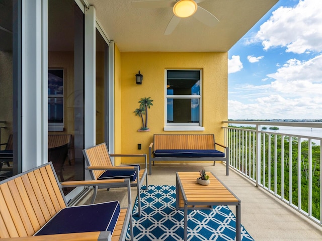 balcony with a water view and ceiling fan