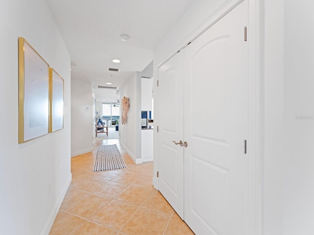 hall with light tile patterned floors