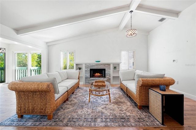 living room with vaulted ceiling with beams and dark wood-type flooring