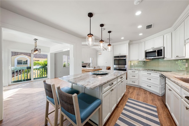 kitchen featuring a center island, white cabinets, and appliances with stainless steel finishes