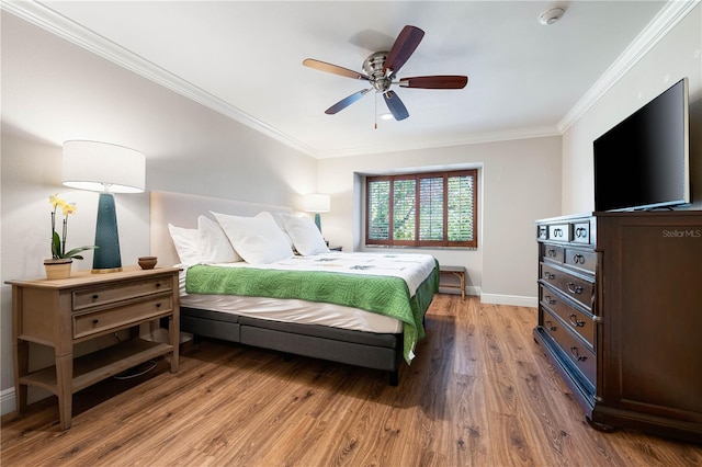 bedroom with wood-type flooring, ceiling fan, and crown molding