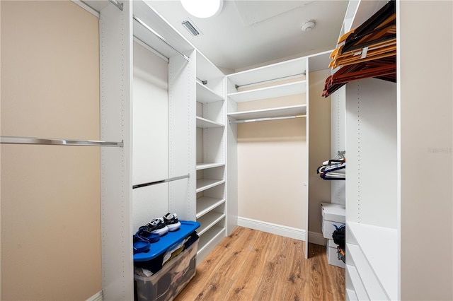 walk in closet featuring light hardwood / wood-style flooring