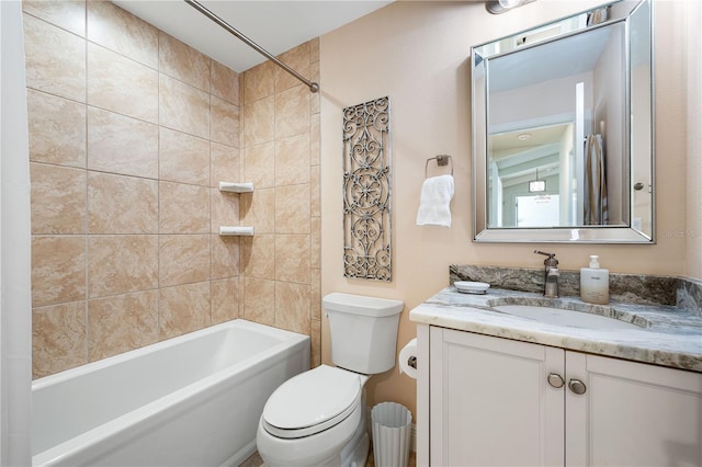 full bathroom featuring vanity, toilet, and tiled shower / bath