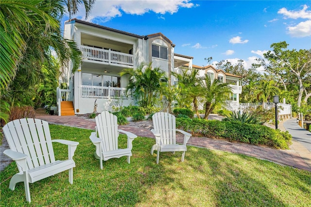 exterior space with a balcony and a yard