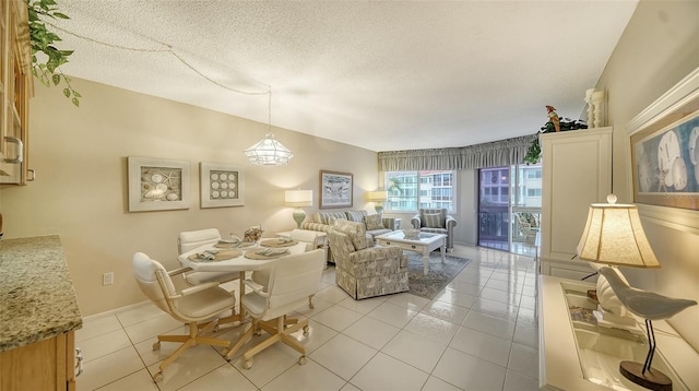 tiled dining space featuring a textured ceiling