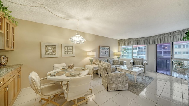 tiled dining area featuring a textured ceiling