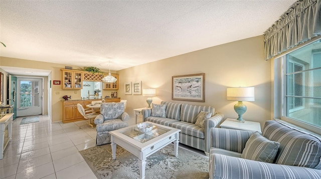 living room featuring light tile flooring and a textured ceiling