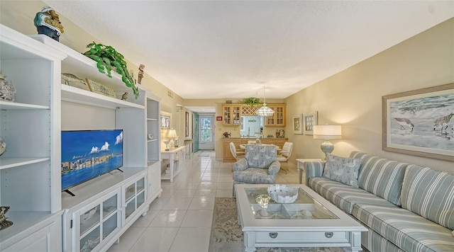 tiled living room featuring a textured ceiling