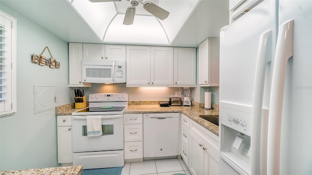 kitchen featuring light tile floors, light stone countertops, ceiling fan, white appliances, and white cabinets