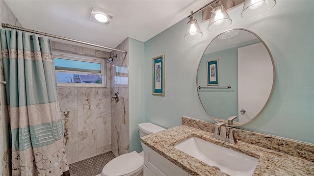 bathroom with vanity, a shower with shower curtain, and toilet