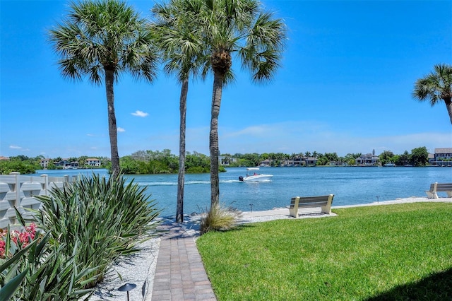 view of dock with a water view and a yard