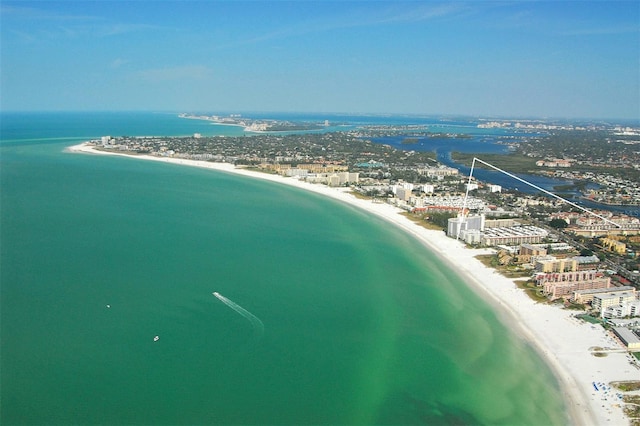 birds eye view of property featuring a beach view and a water view