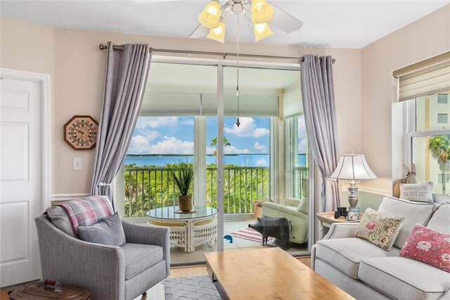 living room featuring ceiling fan and plenty of natural light