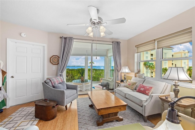 living room featuring light hardwood / wood-style floors and ceiling fan