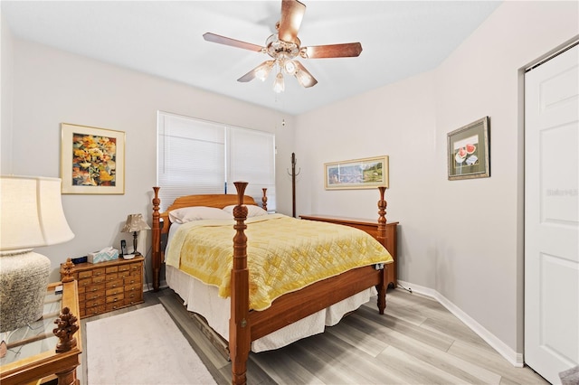 bedroom with wood-type flooring and ceiling fan