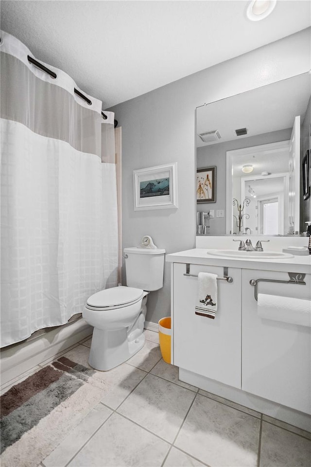 full bathroom with vanity, toilet, shower / bathtub combination with curtain, and tile patterned floors