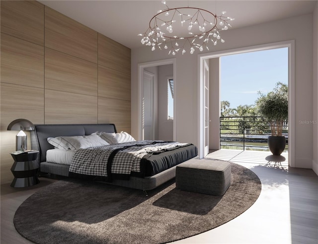 bedroom featuring access to outside and a chandelier