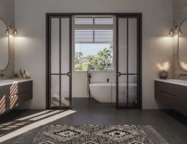 bathroom featuring vanity and a bath