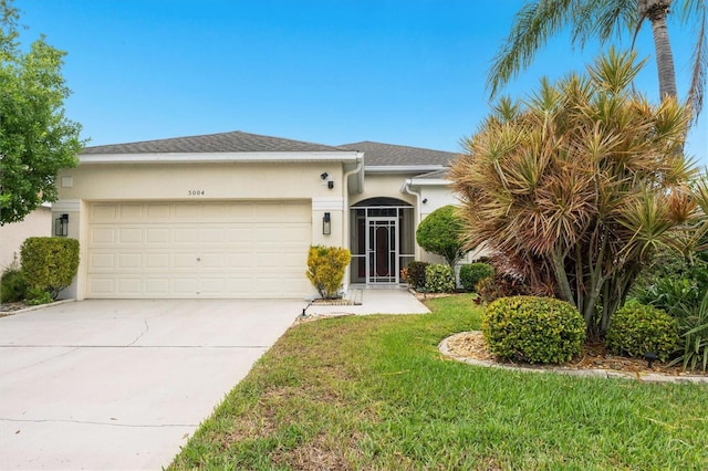 view of front of home featuring a garage and a front lawn