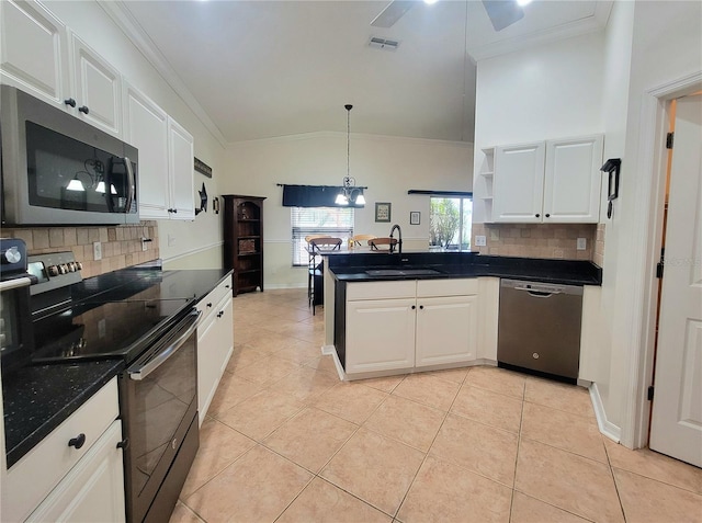 kitchen featuring kitchen peninsula, white cabinetry, sink, and appliances with stainless steel finishes