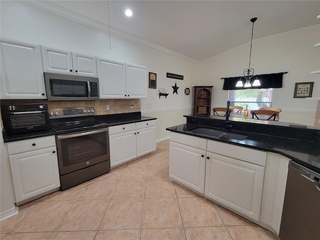 kitchen with light tile patterned floors, stainless steel appliances, white cabinetry, and sink