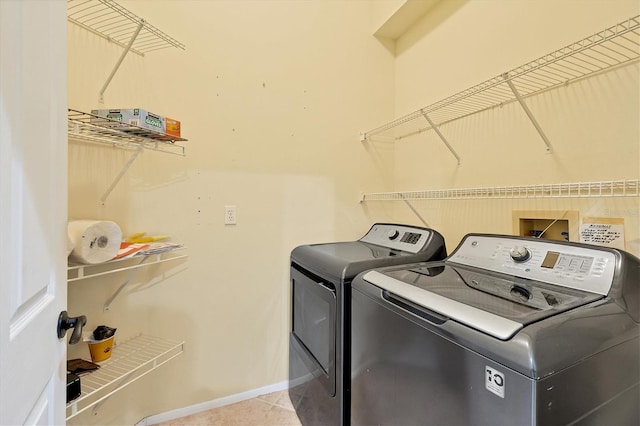 washroom with washing machine and clothes dryer