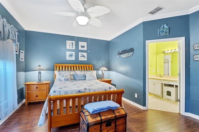 bedroom featuring ceiling fan, crown molding, dark wood-type flooring, sink, and connected bathroom