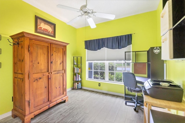 home office with ceiling fan and light hardwood / wood-style flooring