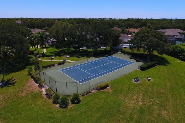 view of tennis court with a lawn