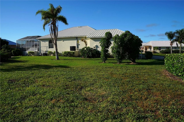 view of property exterior with a lanai and a lawn