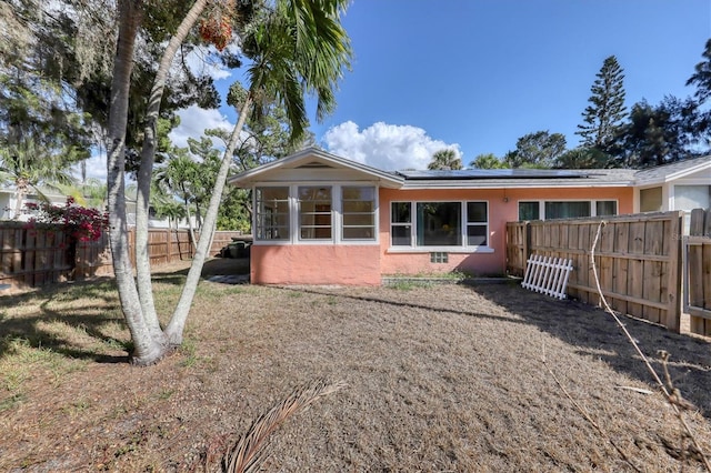 back of house with a sunroom