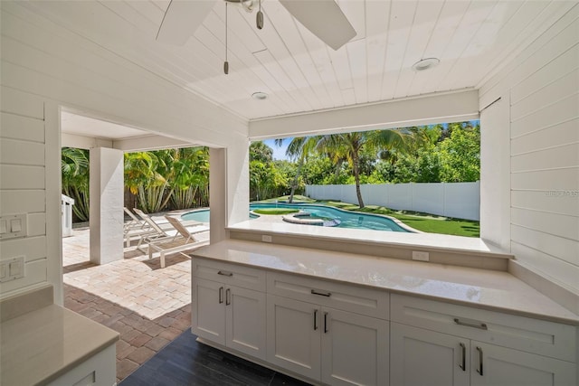 view of patio with a fenced in pool and ceiling fan