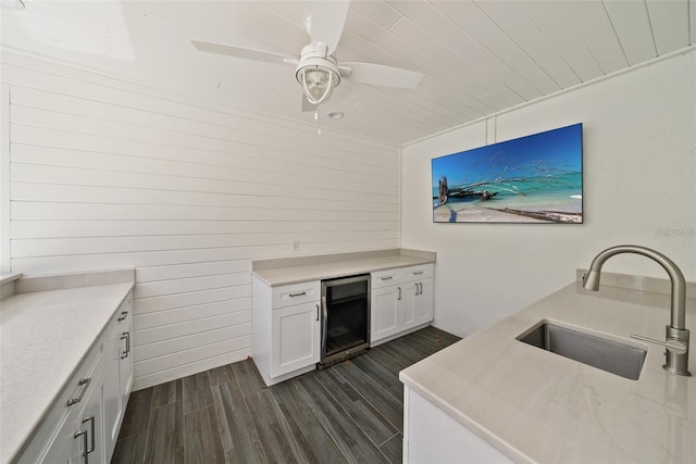 kitchen with ceiling fan, dark hardwood / wood-style flooring, white cabinets, sink, and wine cooler