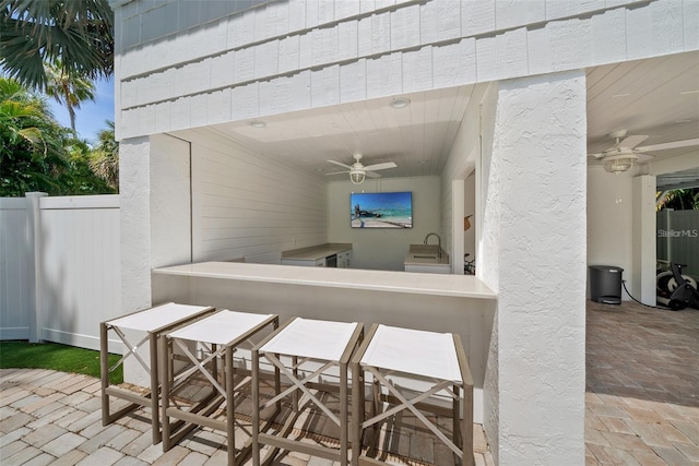 view of patio / terrace featuring sink and ceiling fan