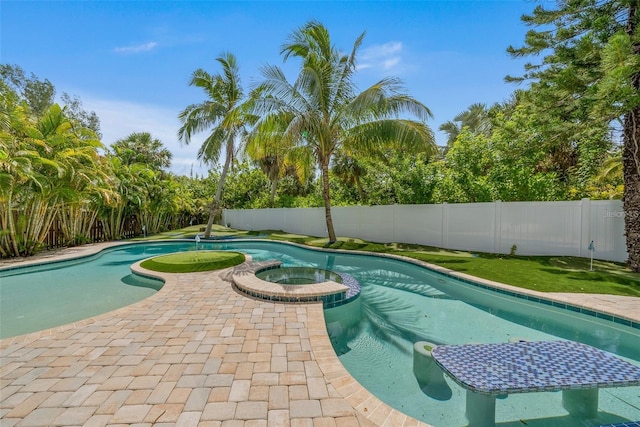 view of pool with an in ground hot tub