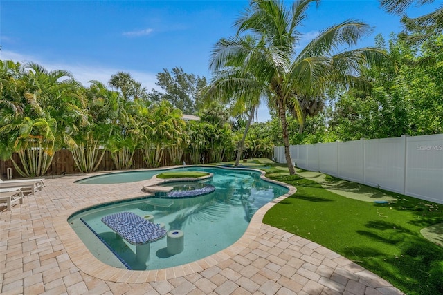 view of swimming pool featuring a patio area and an in ground hot tub