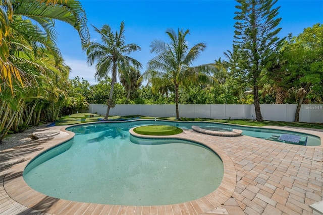 view of pool with an in ground hot tub