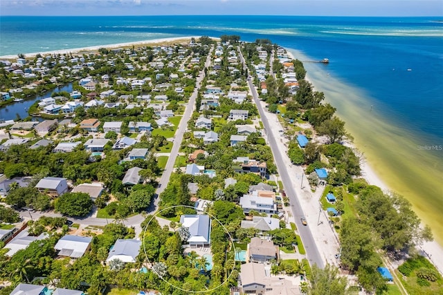 birds eye view of property with a water view and a view of the beach