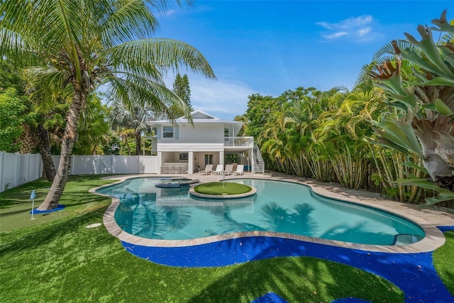 view of pool featuring an in ground hot tub, a patio, and a lawn