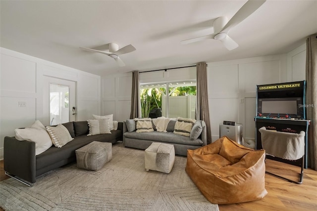 living room featuring light hardwood / wood-style flooring and ceiling fan