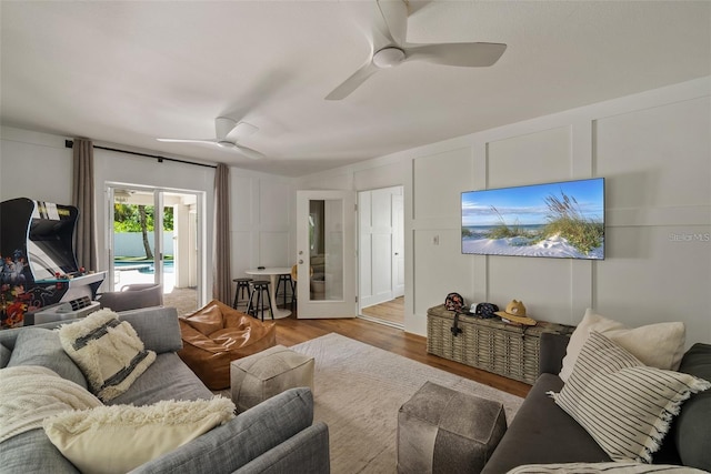 living room with ceiling fan and light wood-type flooring